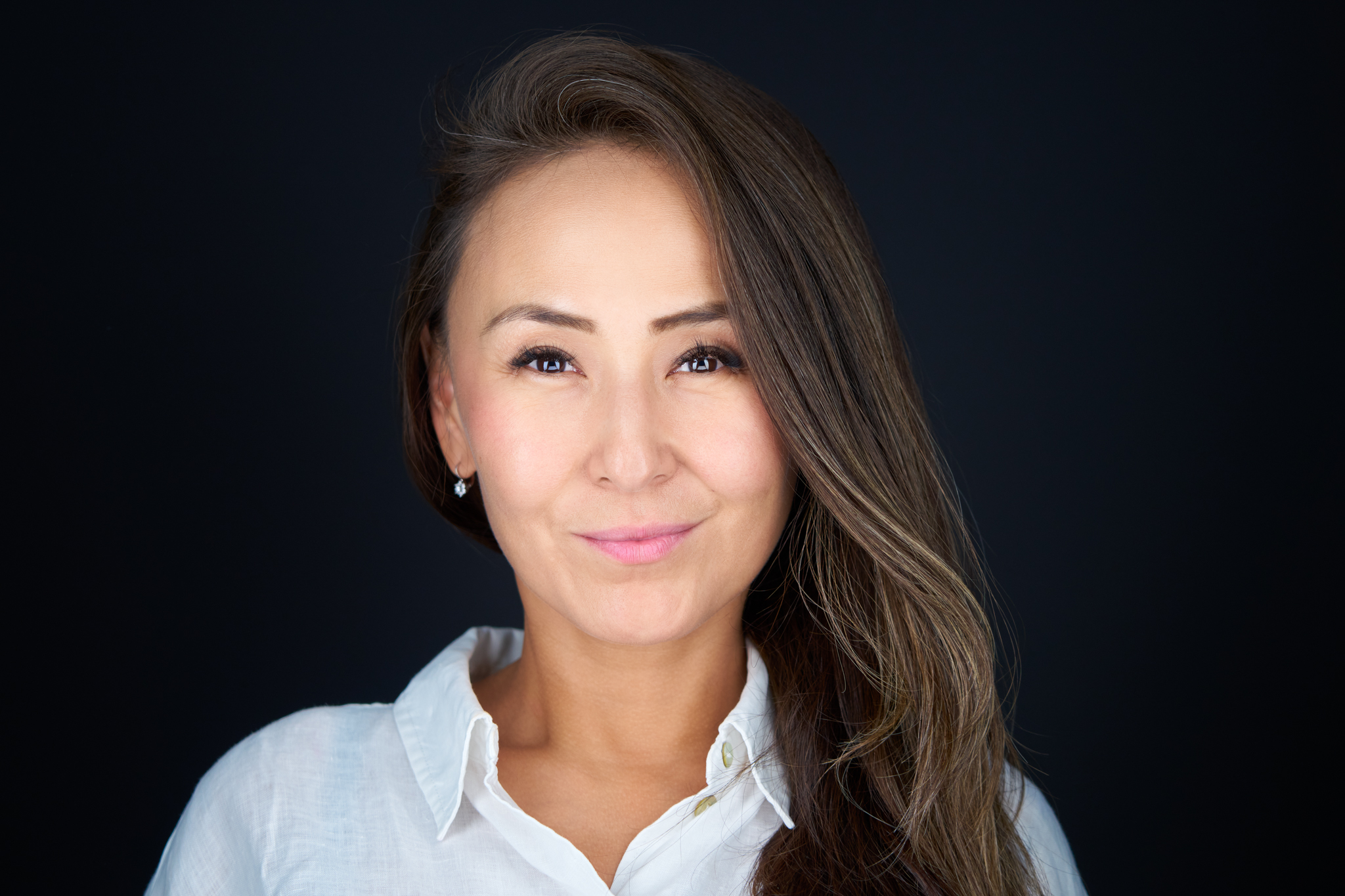 Studio headshot of a woman with dark hair